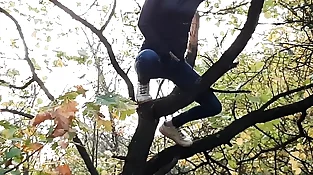 Lady strokes on a tall tree in a public place - Lesbian-illusion